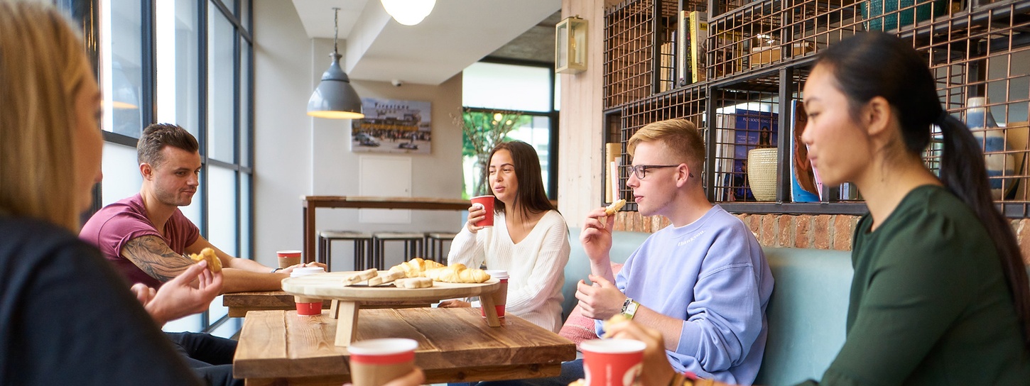 University students living in the Collegiate halls of residence eating together.