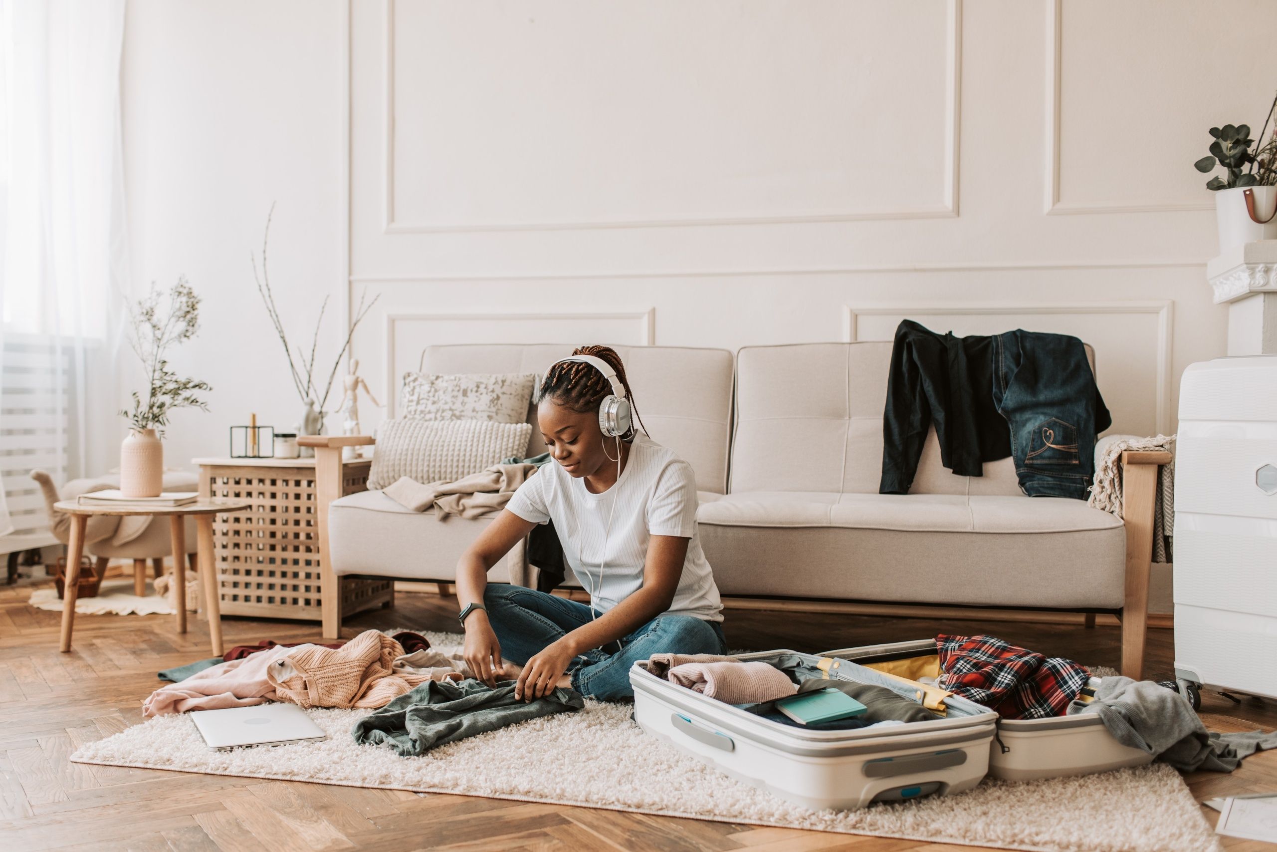University student preparing all the things she will take with her to Milan in order to make the most of her experience abroad. 