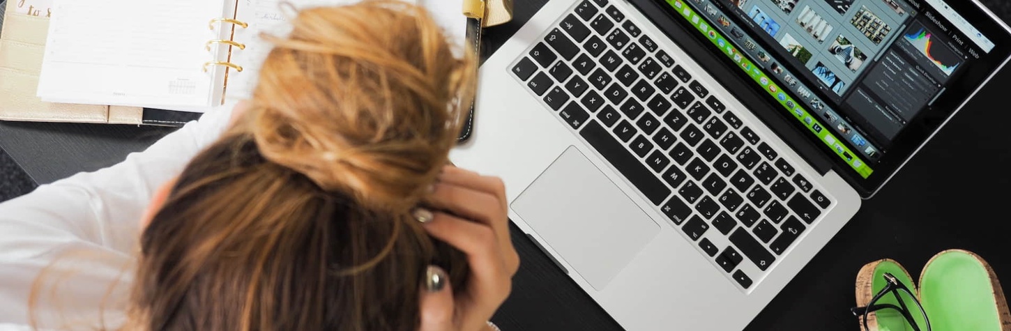 A woman in front of a computer while organising her university curriculum.